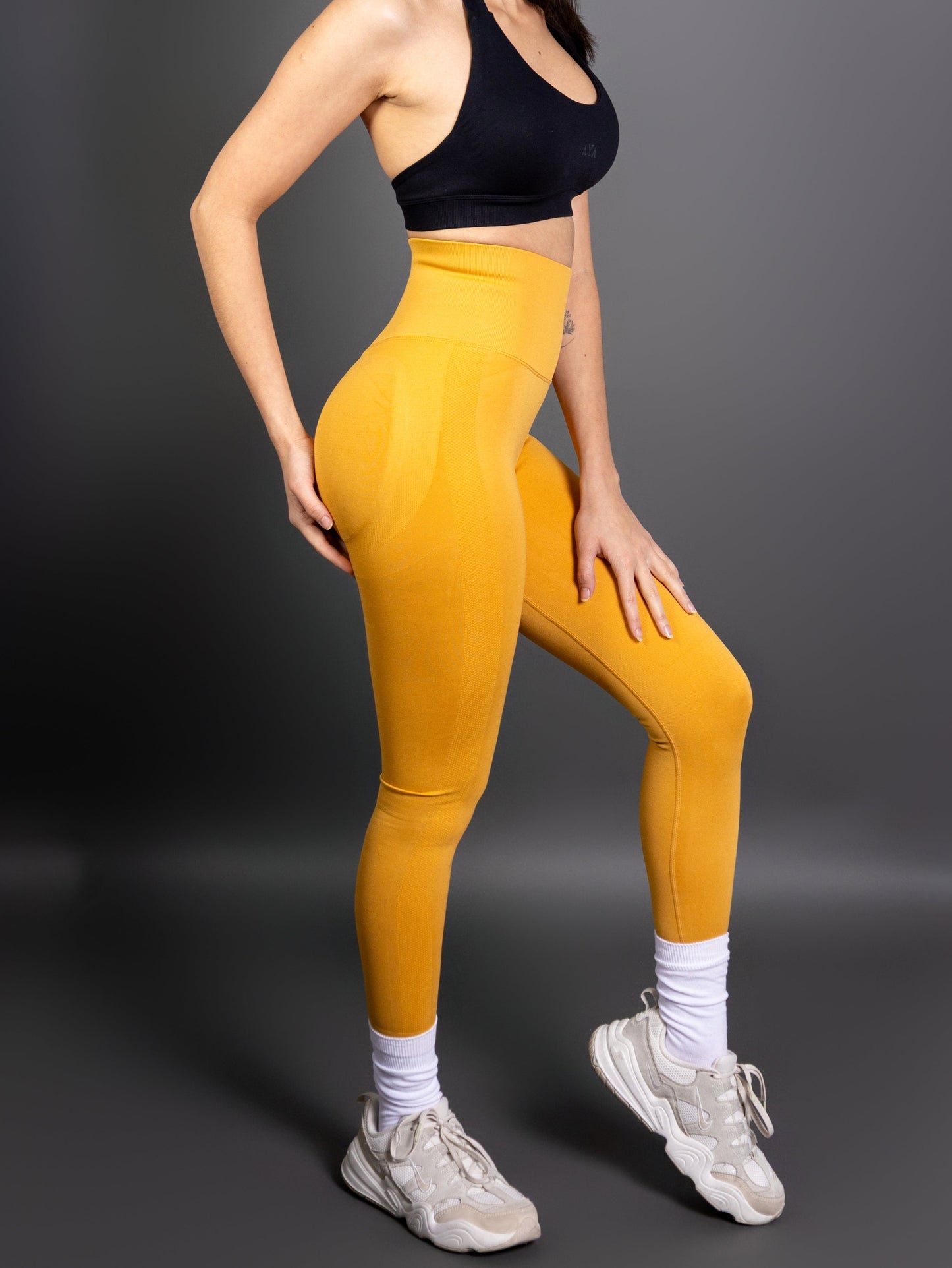 Close-up of woman wearing sky blue high-waisted seamless AYA leggings – sculpting fit that accentuates natural curves with a soft, confident aesthetic.